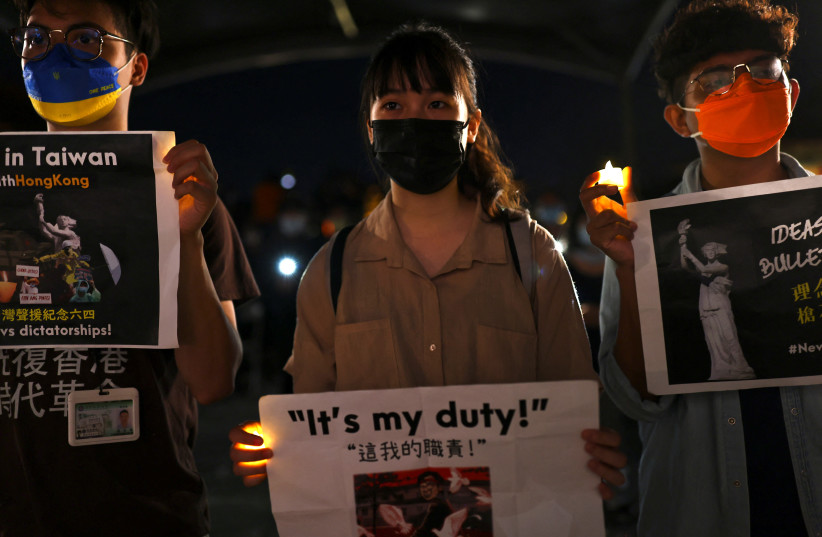 Taiwanese gather to commemorate the 33rd anniversary of Beijing's Tiananmen crackdown in Taipei (photo credit: REUTERS)