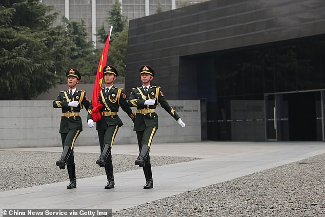 A Chinese army report from 2022 identified 'five battles of cognition' to shape future conflicts. Pictured:&nbsp;The Guard of Honor of the Chinese People's Liberation Army (PLA) perform a flag-raising ceremony