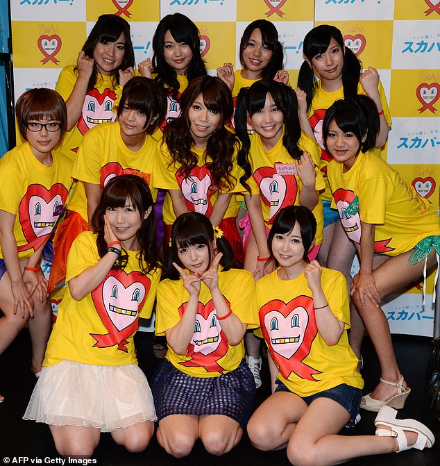 Many girls and women fall victim to the cruel, and often inescapable traps, as they are desperate for a job and money.&nbsp;Pictured: Nine adult Japanese porn actresses in Tokyo on August 30, 2014, as they were preparing to have their breasts squeezed by fans for 24 hours for a charity event loosely translated as 'Boob Aid'