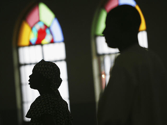 Nigerian Catholic worshippers stand during morning mass April 12, 2005 in Kano, Nigeria. Kano is part of Nigeria's primarily Muslim north, but devoted Catholic minority participates in frequent Masses in local cathedrals. Cardinal Francis Arinze of Nigeria is considered a leading contender to become pope in the aftermath of the �K