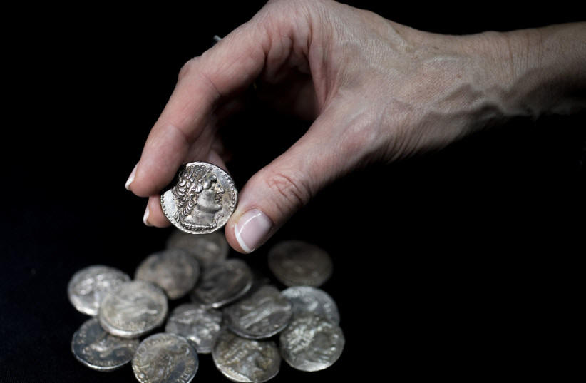  A wooden box containing 15 silver coins from the Maccabean period was discovered in the Judean Desert earlier this year, and will be put on display in the Hasmonean Museum in Modi'in, December 13, 2022. (photo credit: SHAI HALEVI / ISRAEL ANTIQUITIES AUTHORITY)