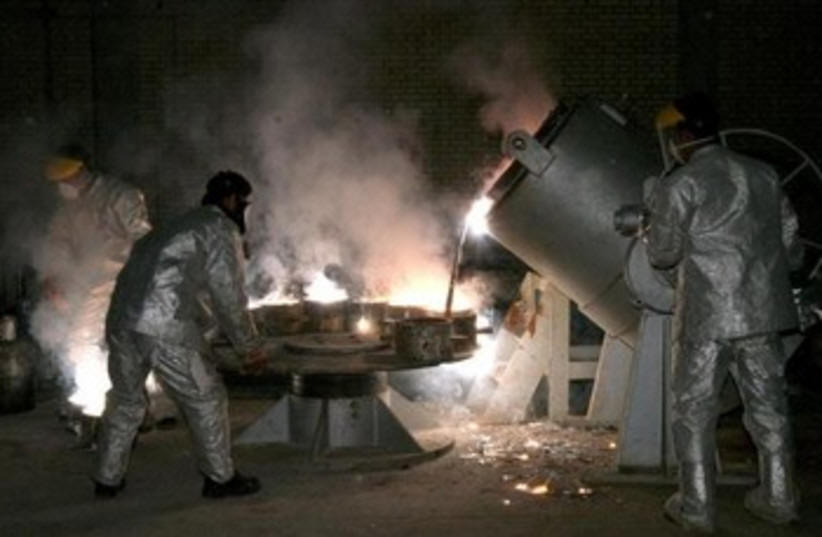 Iranian technicians work at a uranium processing site in Isfahan. (photo credit: REUTERS)