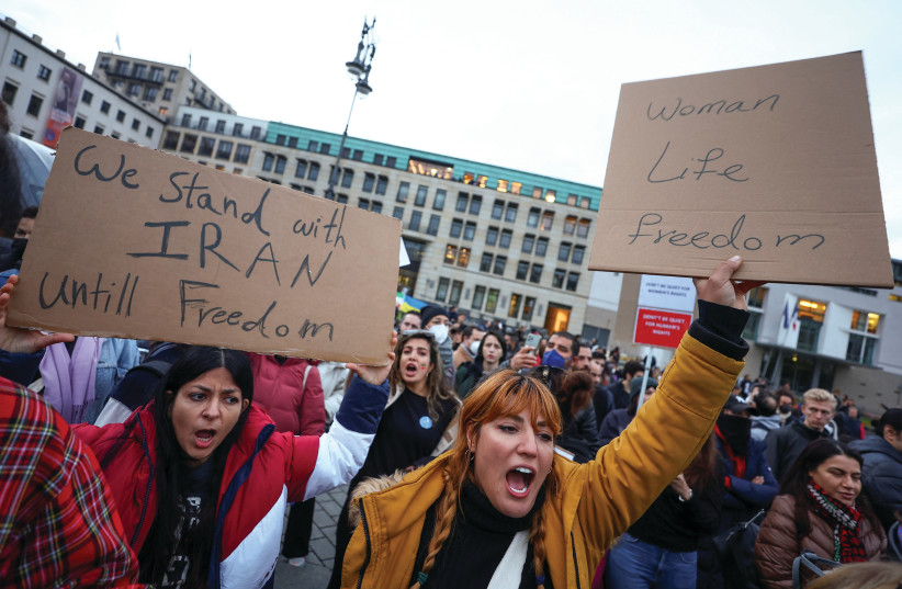  DEMONSTRATORS NEAR THE Brandenburg Gate, in Berlin, on Wednesday, hold placards during a protest following the death of Mahsa Amini in Iran. (credit: Lisi Niesner/Reuters)