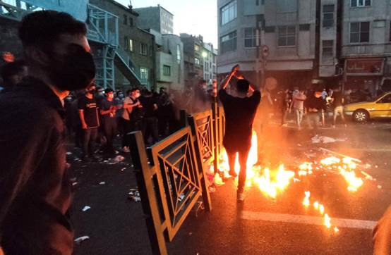 People light a fire during a protest over the death of Mahsa Amini, a woman who died after being arrested by the Islamic republic's ''morality police'', in Tehran, Iran, September 21, 2022. (credit: WANA (WEST ASIA NEWS AGENCY) VIA REUTERS/FILE PHOTO)