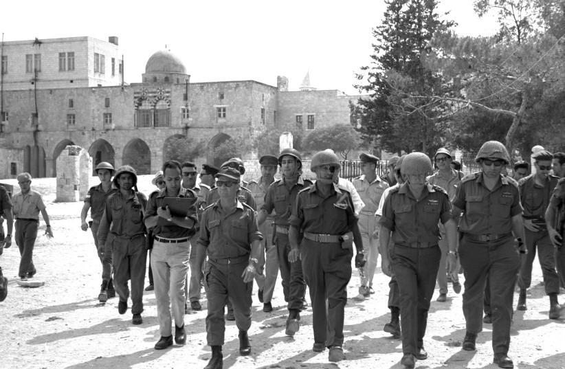 ��STATUS QUO�� creator: Defense minister Moshe Dayan (2nd from L.)  walks through the Old City during the Six Day War, 1967, accompanied by chief of staff Yitzhak Rabin, Gen. Rehavam Ze��evi and Gen. Uzi Narkiss. (credit: GPO FLICKR)