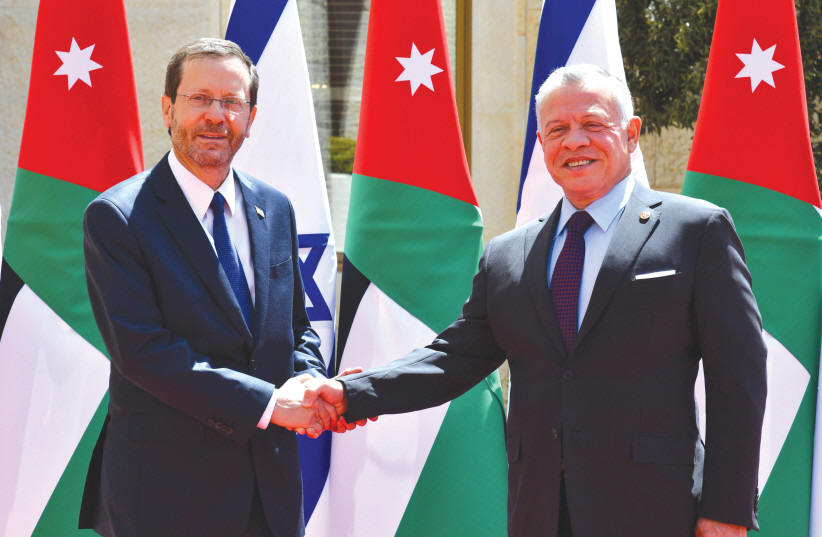  PRESIDENT ISAAC HERZOG shakes hands with Jordan��s King Abdullah II in Amman, last year. It��s ridiculous that the Israel-Jordan peace deal gives the kingdom a special role at the Temple Mount, says the writer. (photo credit: HAIM ZACH/GPO)