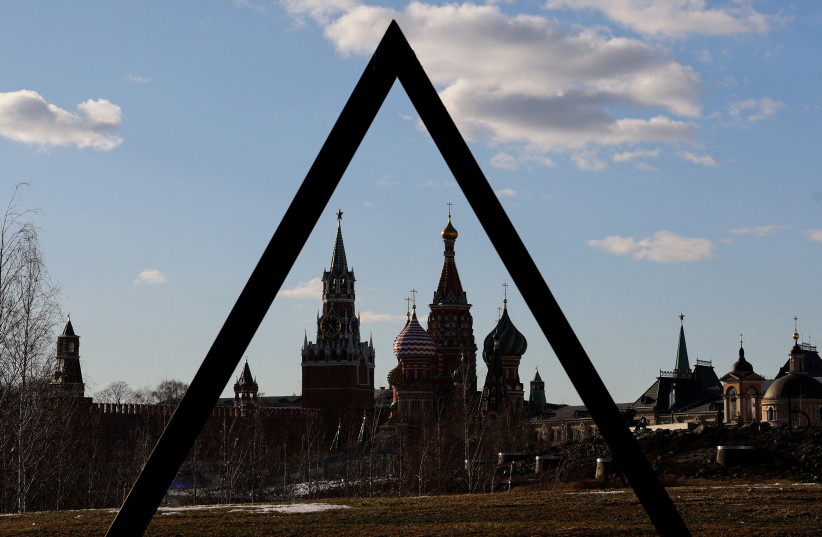  The Kremlin's Spasskaya Tower and St. Basil's Cathedral are seen through an art object in Zaryadye park in Moscow, Russia March 15, 2022.  (photo credit: EVGENIA NOVOZHENINA/REUTERS)