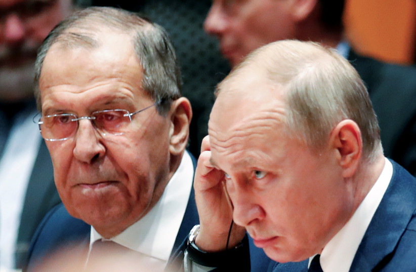  Russian president Vladimir Putin and foreign minister Sergei Lavrov attend the Libya summit in Berlin, Germany, January 19, 2020 (photo credit: HANNIBAL HANSCHKE/REUTERS)