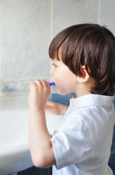 child brushing teeth